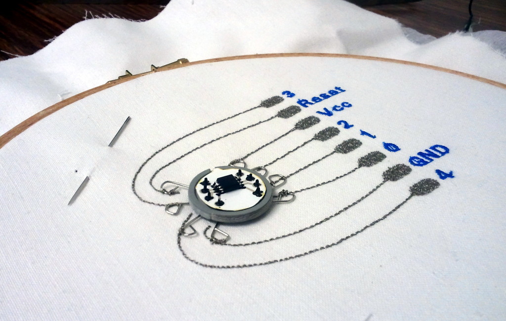 Button on sewn circuit